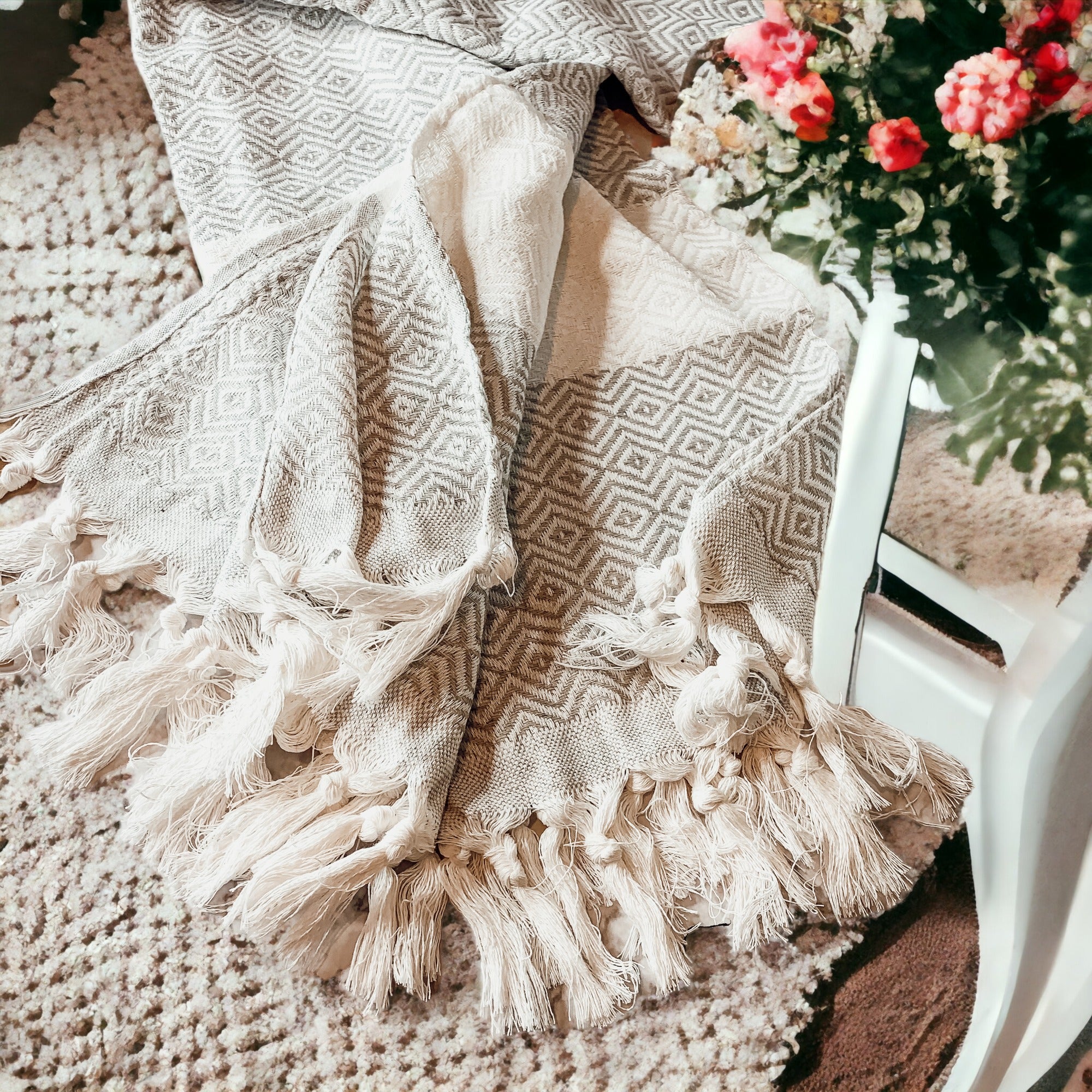 A luxurious Diamond Towel 200GSM in blue with decorative tassels, showcasing its oversized design and unique diamond pattern.