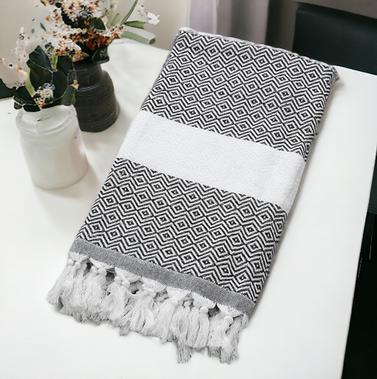 A luxurious Diamond Towel 200GSM in blue with decorative tassels, showcasing its oversized design and unique diamond pattern.