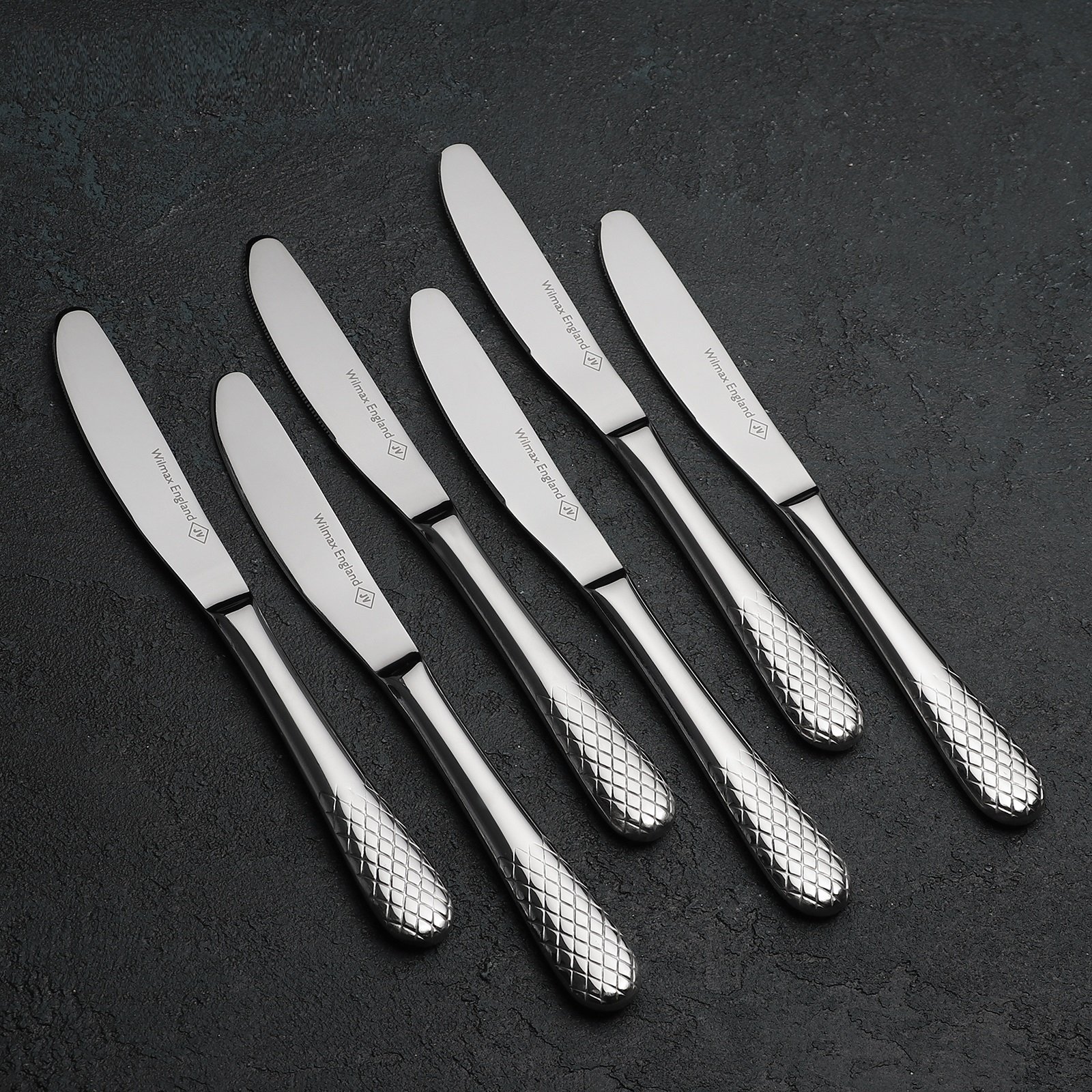 A set of six elegant WILMAX dinner knives, showcasing high polish stainless steel with finely balanced handles, presented in exquisite gift packaging.