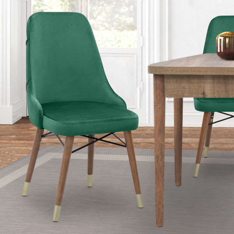 EDMOND velvet dining chair in dark green with walnut and gold legs, showcasing luxurious upholstery and elegant design.