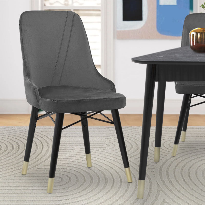 MARK velvet grey dining chair with black and gold legs, showcasing its luxurious design and plush upholstery.