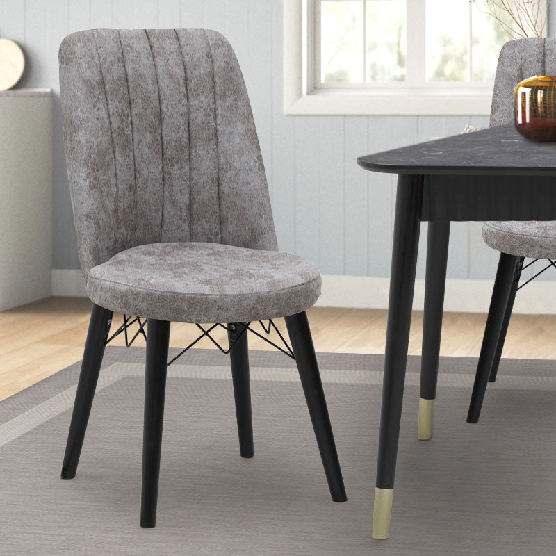 RALU velvet dining chair in grey with black wooden legs, showcasing its elegant design and plush upholstery.