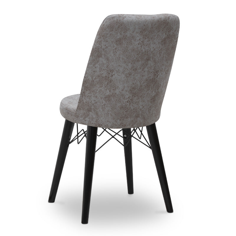 RALU velvet dining chair in grey with black wooden legs, showcasing its elegant design and plush upholstery.