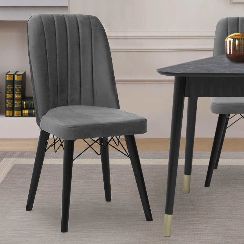 ALFONSO Grey velvet dining chair with black legs and gold detailing, showcasing luxury and elegance.