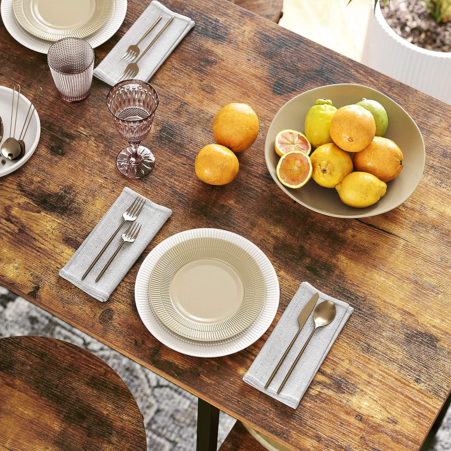 Industrial-style dining table with three shelves, stable steel structure, and rustic brown finish, perfect for dining and storage.