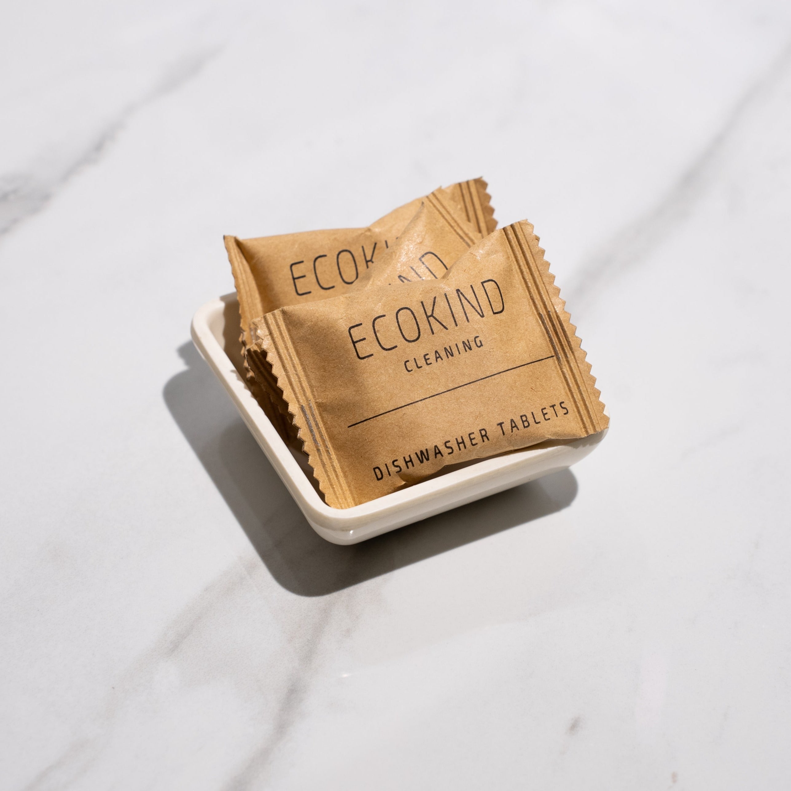 ECOKIND Cleaning dishwasher tablets in eco-friendly packaging, showcasing their plastic-free and plant-based ingredients for effective dish cleaning.