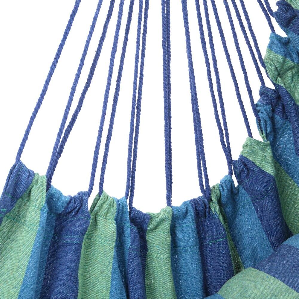 Distinctive blue striped cotton canvas hanging rope chair with pillows, designed for outdoor relaxation and comfort.