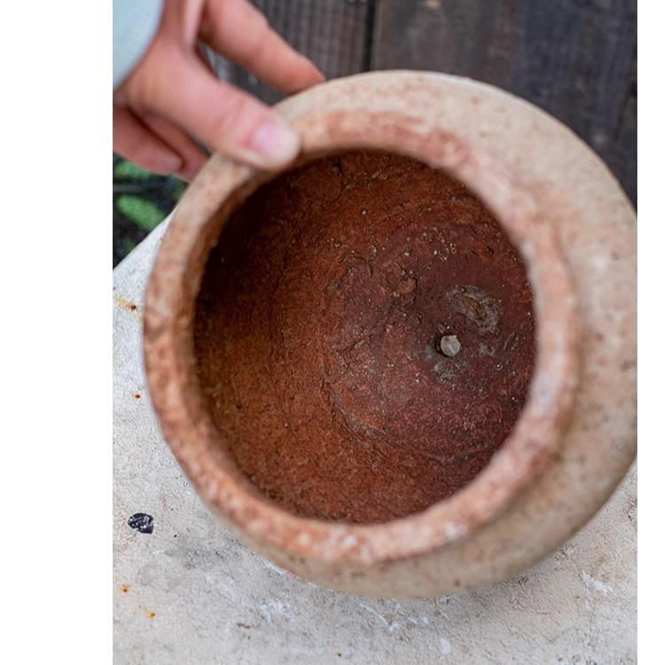 Distressed Cement Plant Pot in terracotta color, showcasing its rustic design and drainage hole.