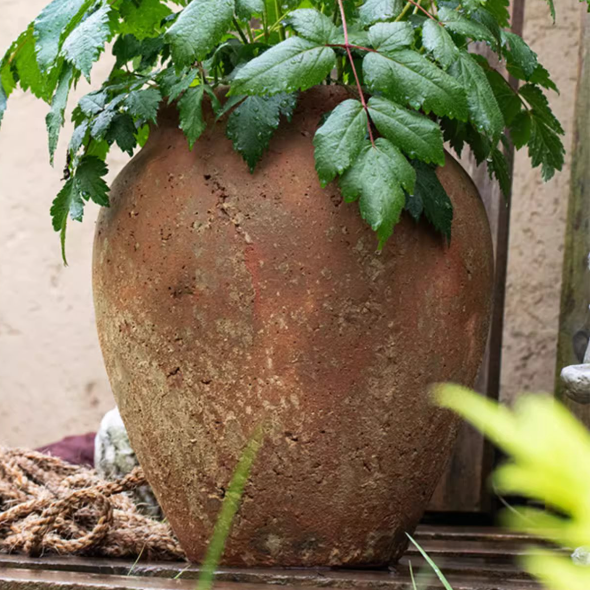 Distressed Cement Plant Pot in terracotta color, showcasing its rustic design and drainage hole.