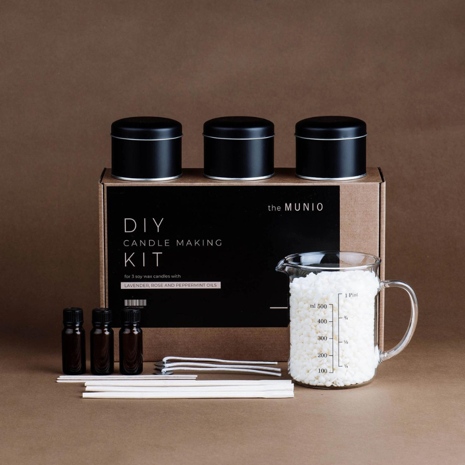 A beautifully arranged DIY Candle Making Kit featuring eco-friendly wax, natural scented oils, wicks, and metal containers.