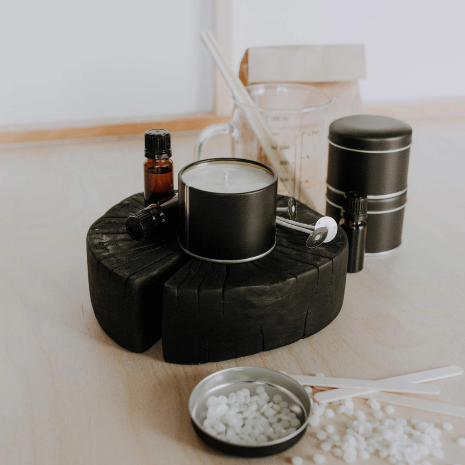 A beautifully arranged DIY Candle Making Kit featuring eco-friendly wax, natural scented oils, wicks, and metal containers.