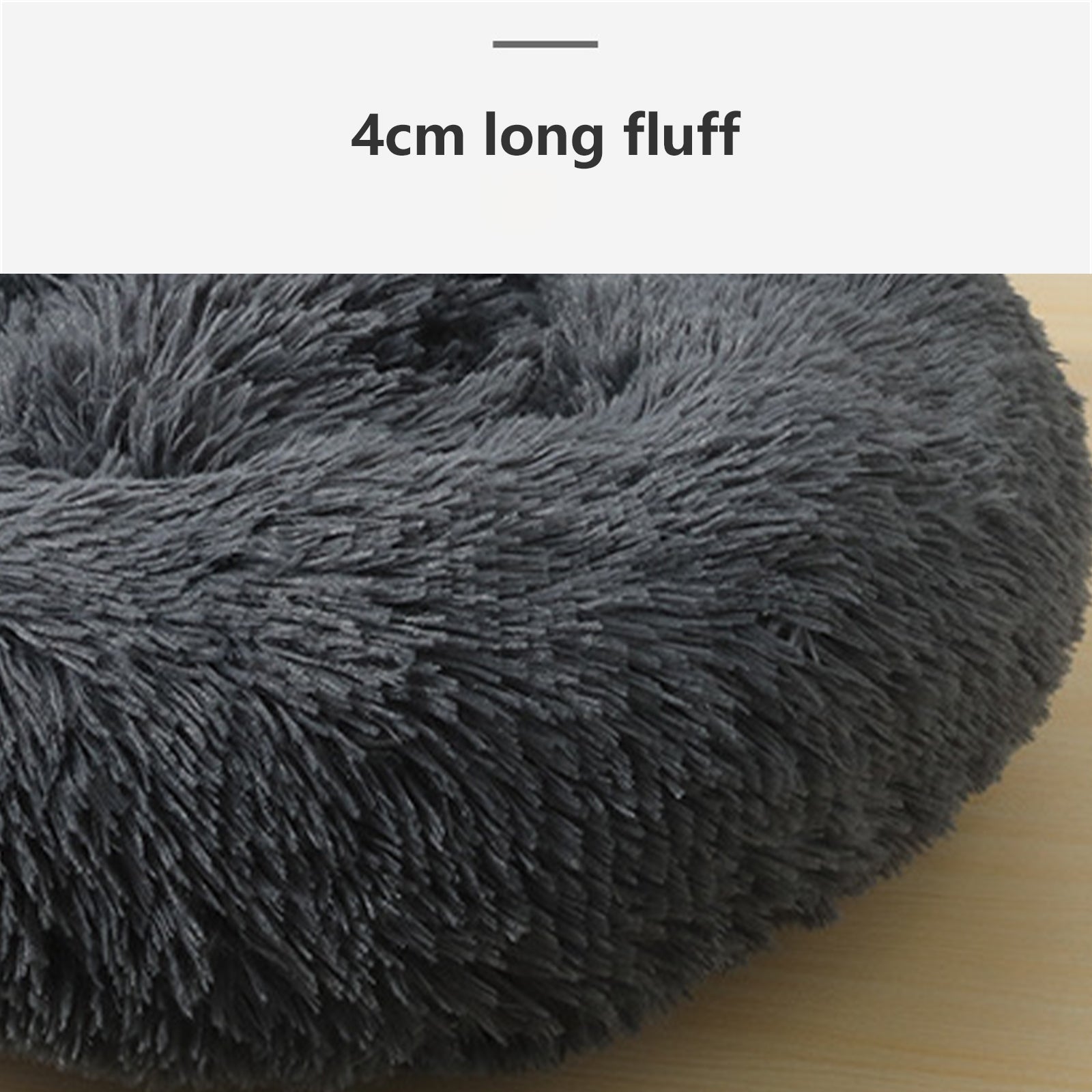 A dark gray plush round dog bed designed for comfort, featuring faux shag fur and a cozy nest shape for pets to snuggle into.