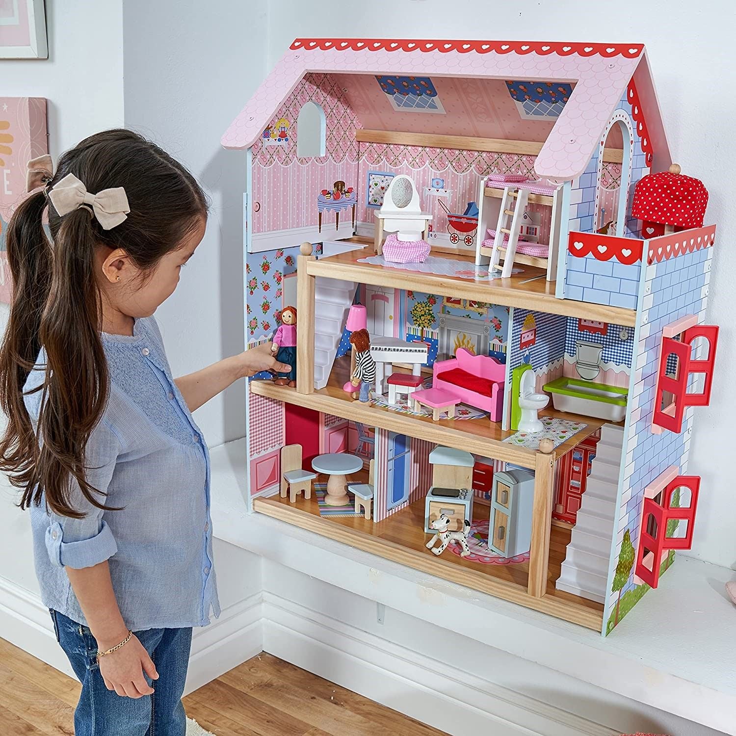 A colorful Doll Cottage with Furniture for kids, featuring three levels, five rooms, and a 16-piece furniture set, designed for imaginative play.