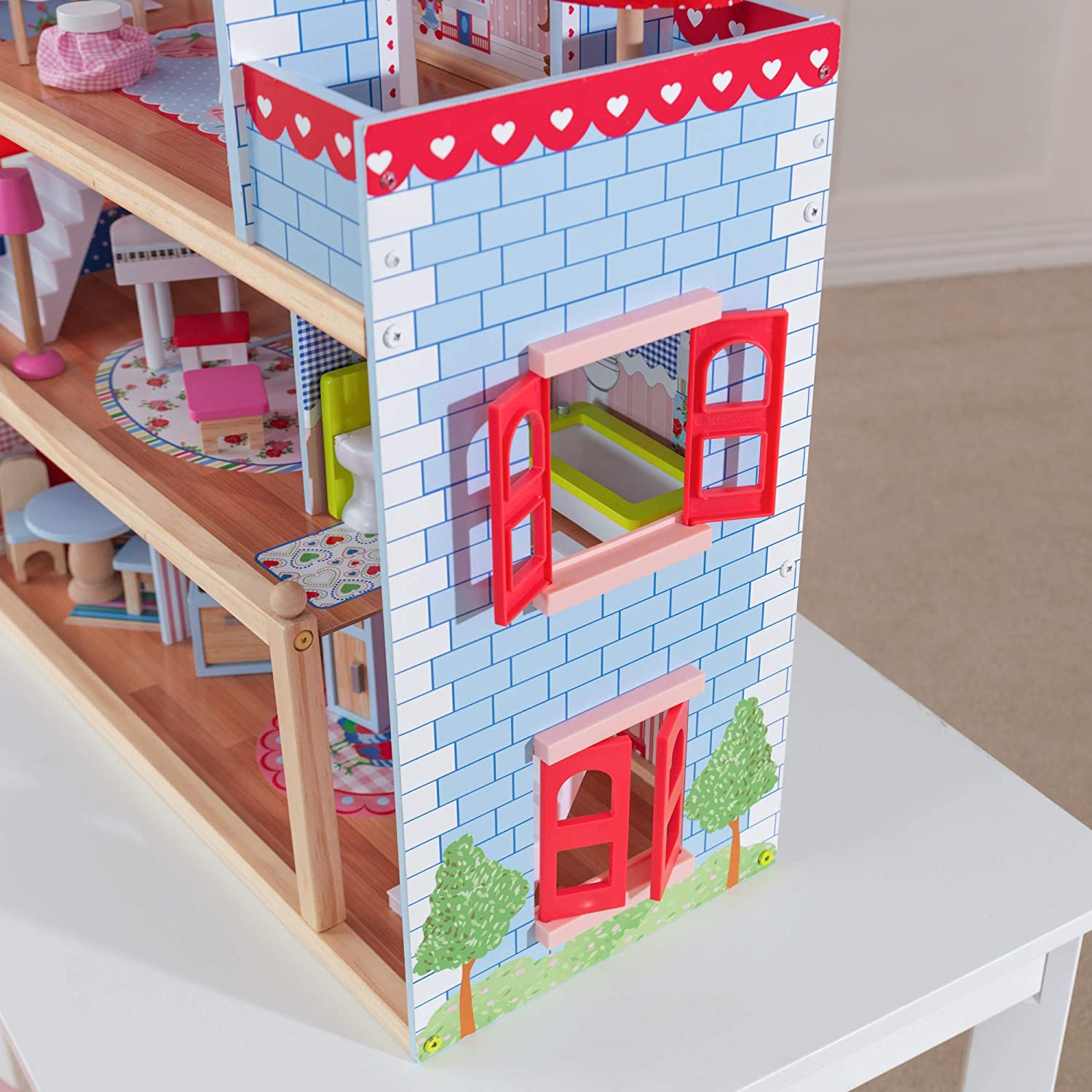 A colorful Doll Cottage with Furniture for kids, featuring three levels, five rooms, and a 16-piece furniture set, designed for imaginative play.