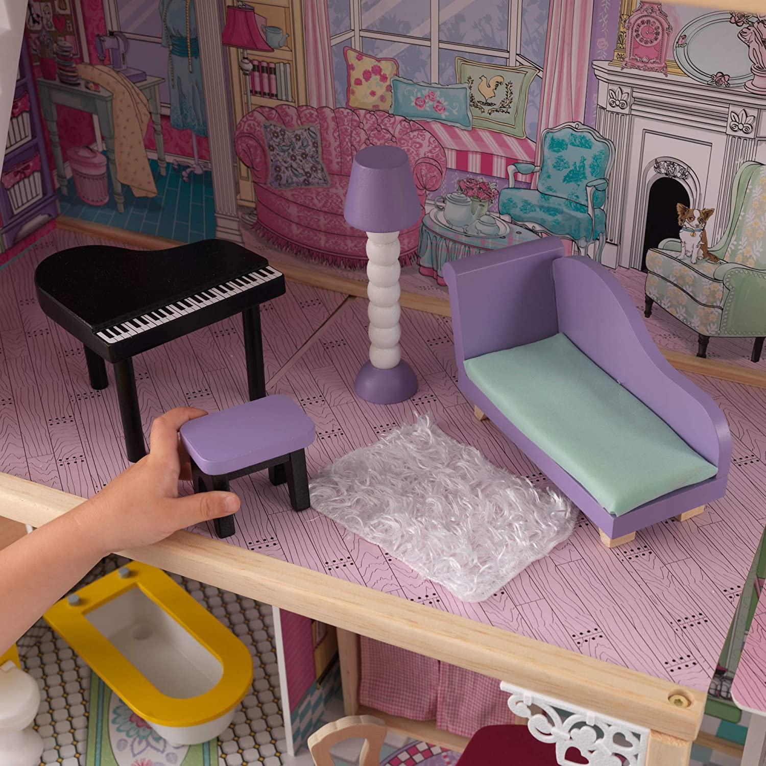 A colorful wooden dollhouse with three levels, four rooms, and a balcony, featuring a gliding elevator and 17 pieces of furniture for imaginative play.