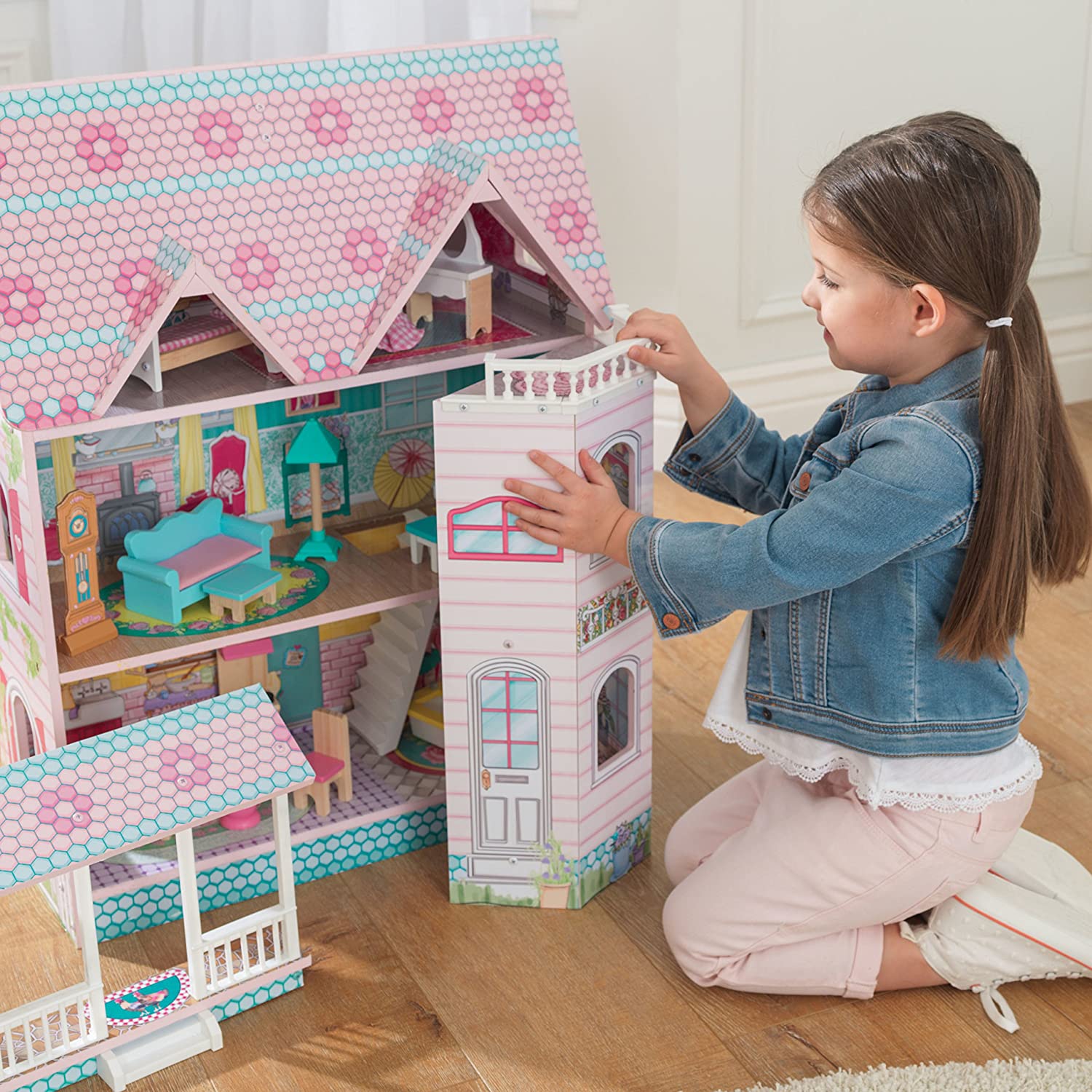 Colorful dollhouse with furniture, featuring three levels and five rooms, designed for imaginative play.