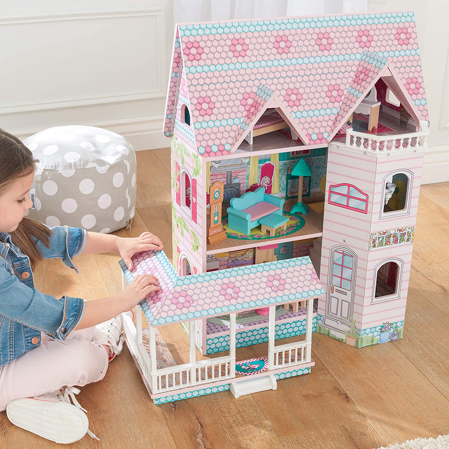 Colorful dollhouse with furniture, featuring three levels and five rooms, designed for imaginative play.