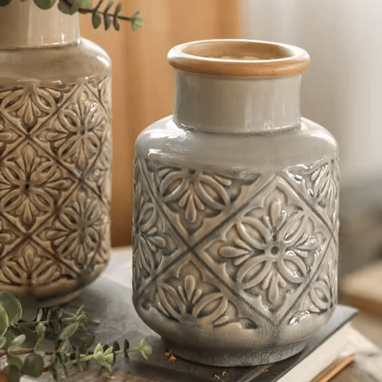 Handmade ceramic vase with a unique embossed pattern in tan, gray, and brown colors, showcasing its elegant glazed finish.