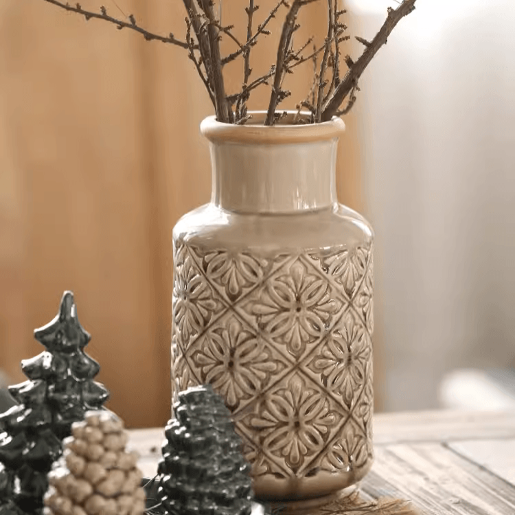 Handmade ceramic vase with a unique embossed pattern in tan, gray, and brown colors, showcasing its elegant glazed finish.