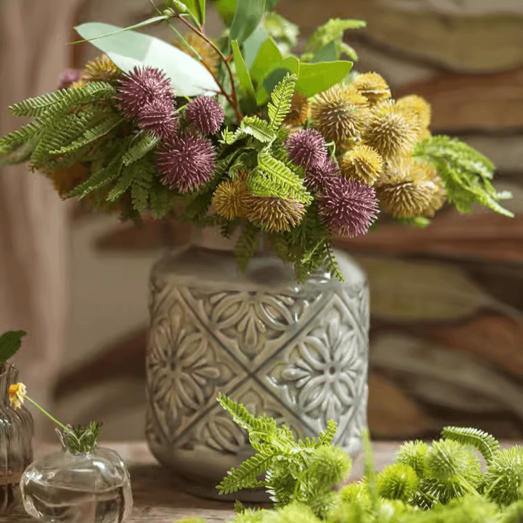 Handmade ceramic vase with a unique embossed pattern in tan, gray, and brown colors, showcasing its elegant glazed finish.