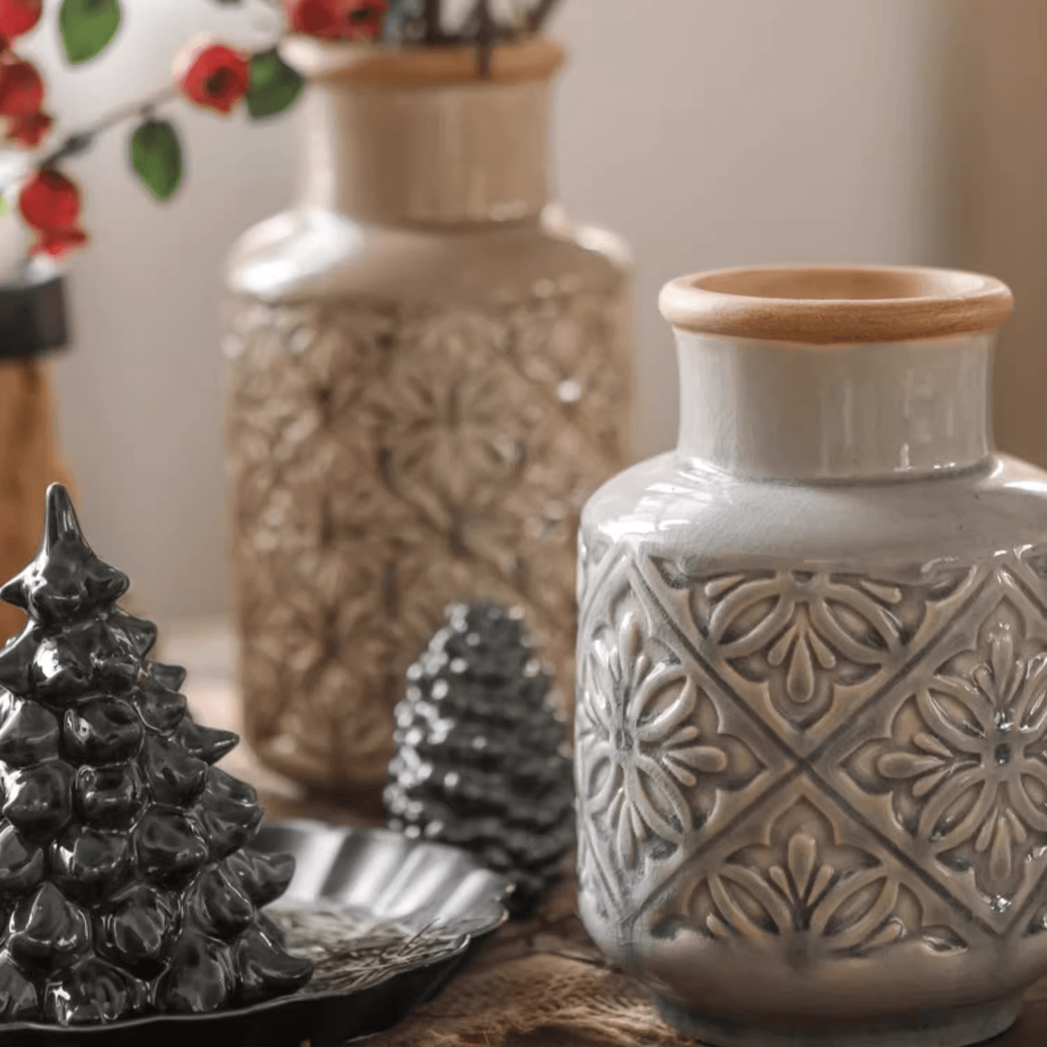 Handmade ceramic vase with a unique embossed pattern in tan, gray, and brown colors, showcasing its elegant glazed finish.