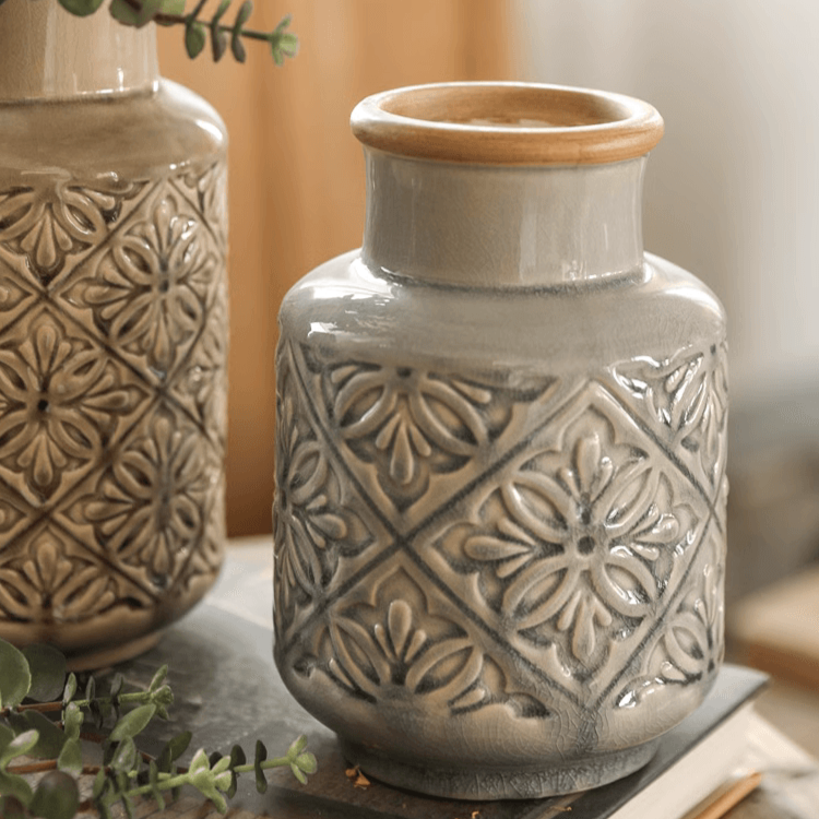 Handmade ceramic vase with a unique embossed pattern in tan, gray, and brown colors, showcasing its elegant glazed finish.