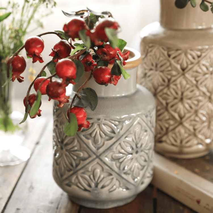 Handmade ceramic vase with a unique embossed pattern in tan, gray, and brown colors, showcasing its elegant glazed finish.