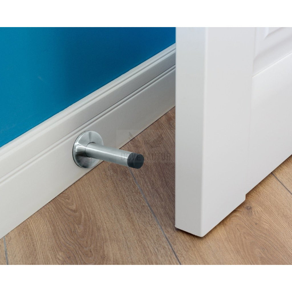 The Dove Factor™ Adhesive Door Stopper in stainless steel and rubber, designed to protect walls and furniture from door damage.