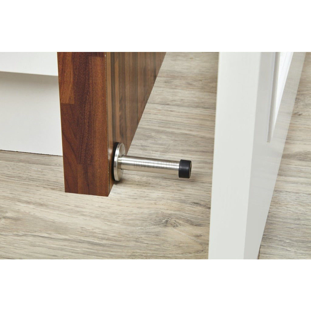 The Dove Factor™ Adhesive Door Stopper in stainless steel and rubber, designed to protect walls and furniture from door damage.