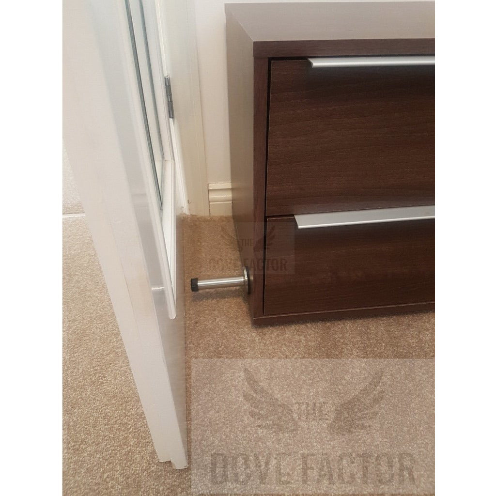 The Dove Factor™ Adhesive Door Stopper in stainless steel and rubber, designed to protect walls and furniture from door damage.