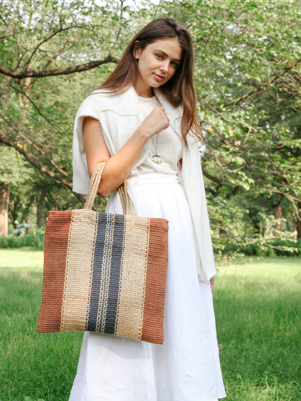 Dora Jute Tote Bag in multi light brown, showcasing handwoven jute fabric and rustic design.