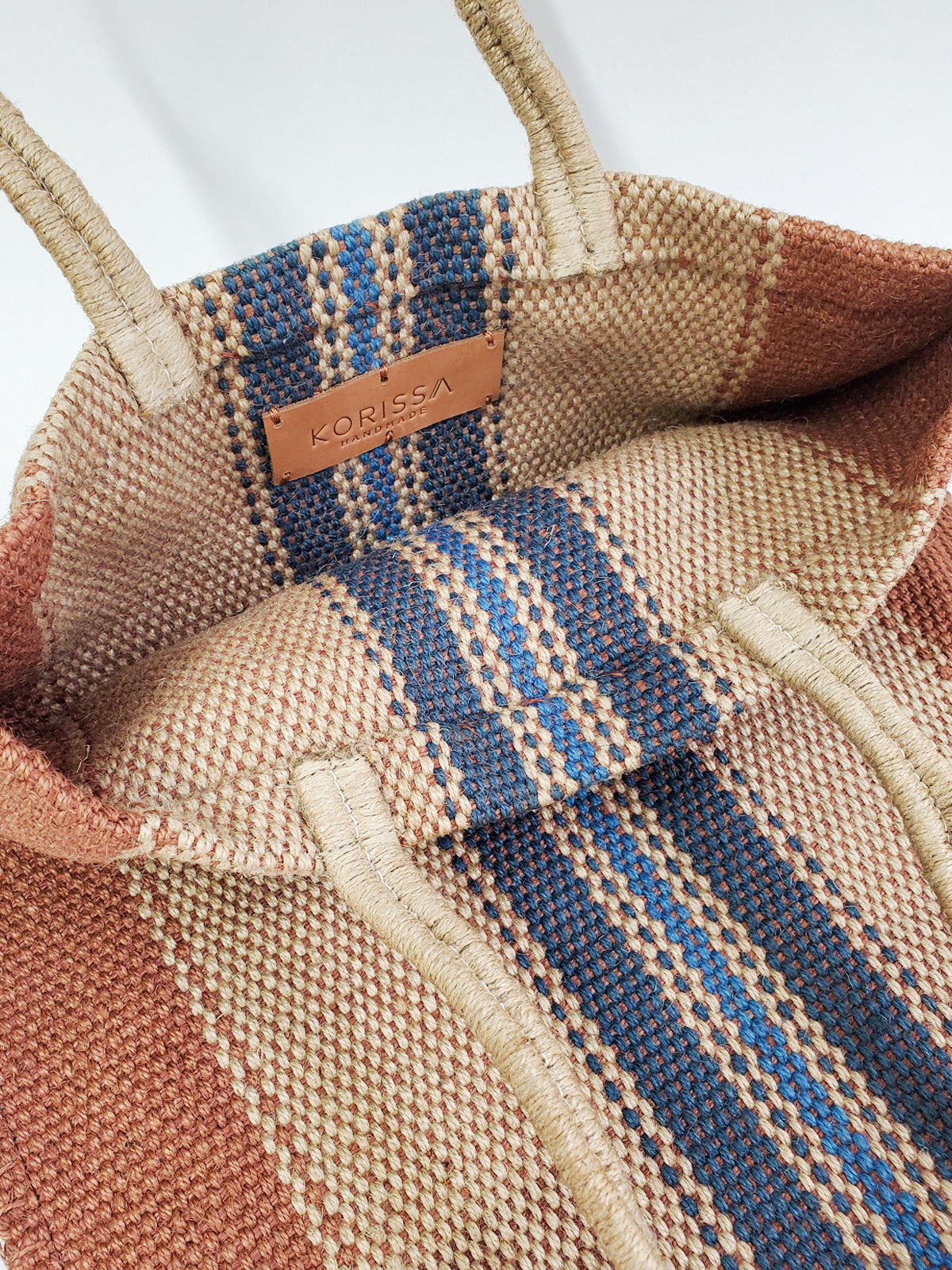 Dora Jute Tote Bag in multi light brown, showcasing handwoven jute fabric and rustic design.