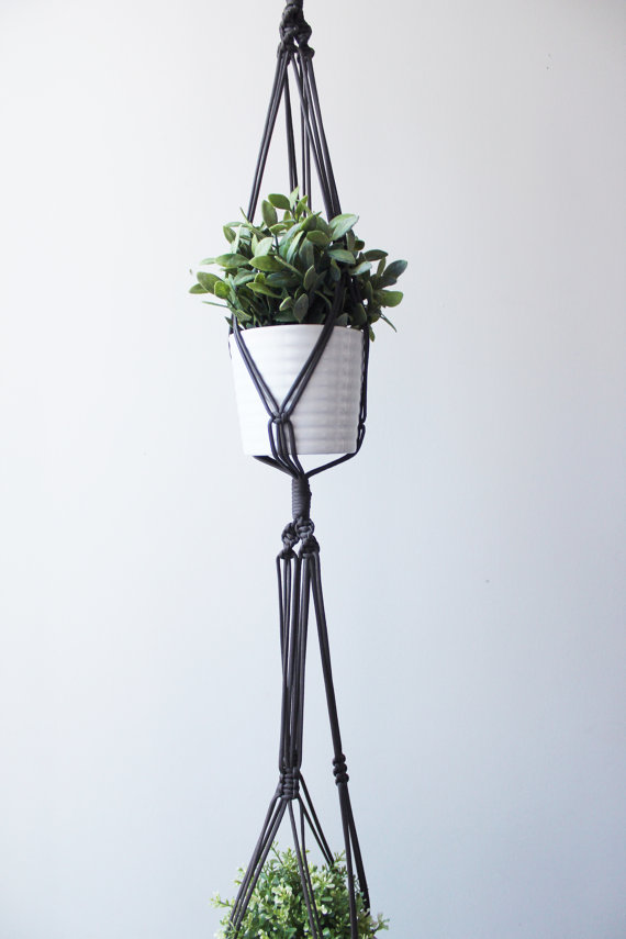 A beautifully crafted Double Macrame Plant Hanger made from durable paracord nylon, showcasing a vibrant green plant in a stylish indoor setting.