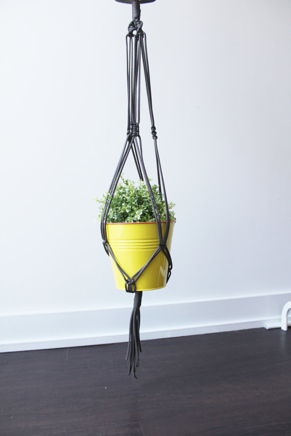 A beautifully crafted Double Macrame Plant Hanger made from durable paracord nylon, showcasing a vibrant green plant in a stylish indoor setting.