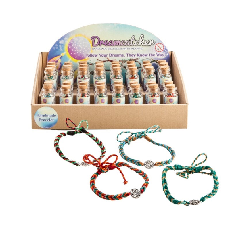 A handmade dreamcatcher bracelet featuring a silver charm and colorful woven band, elegantly displayed in a glass bottle with a cork stopper.