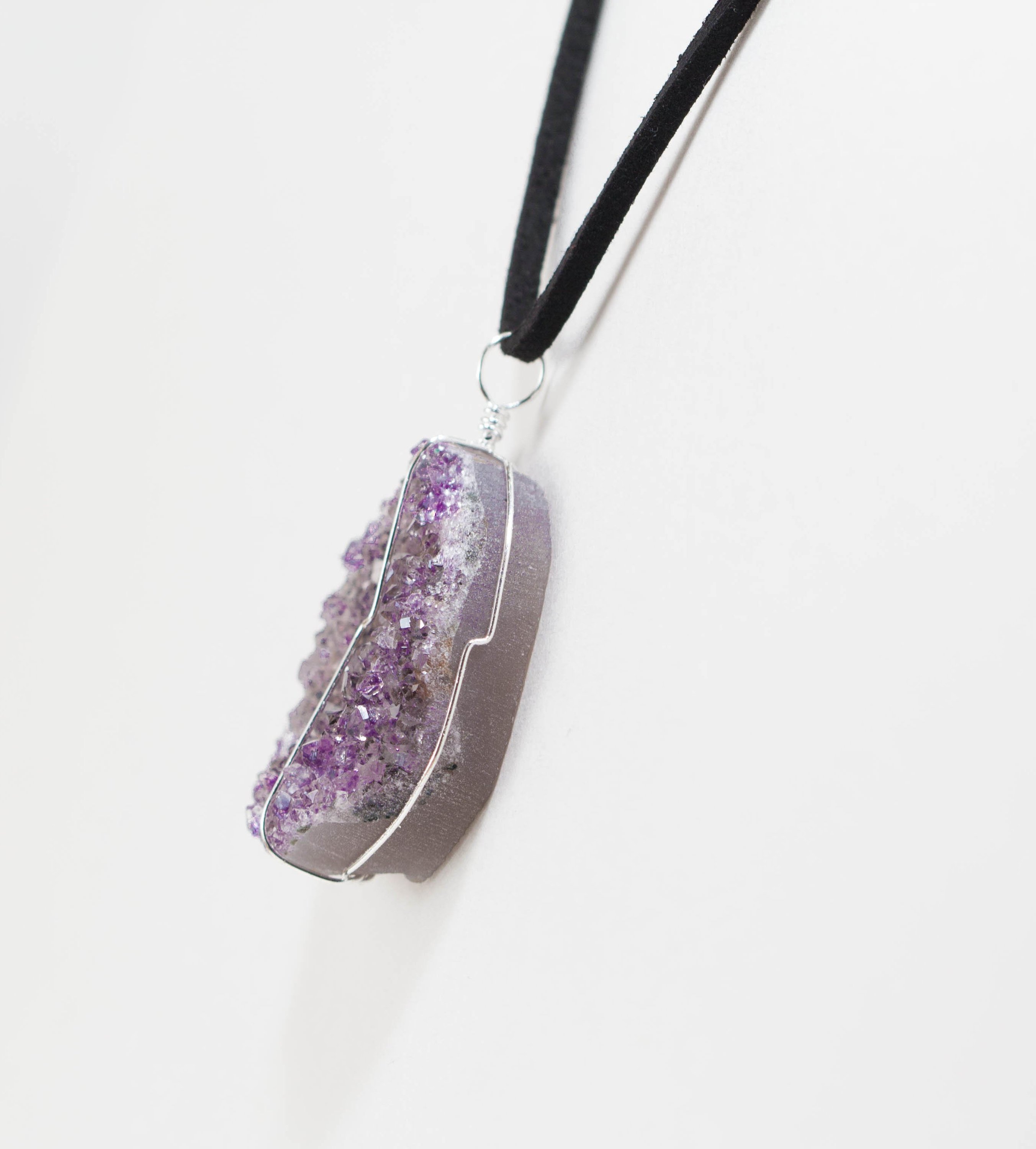 Druse crystal pendant on a leather necklace, showcasing vibrant amethyst, rose amethyst, and citrine crystals secured with silver wire.