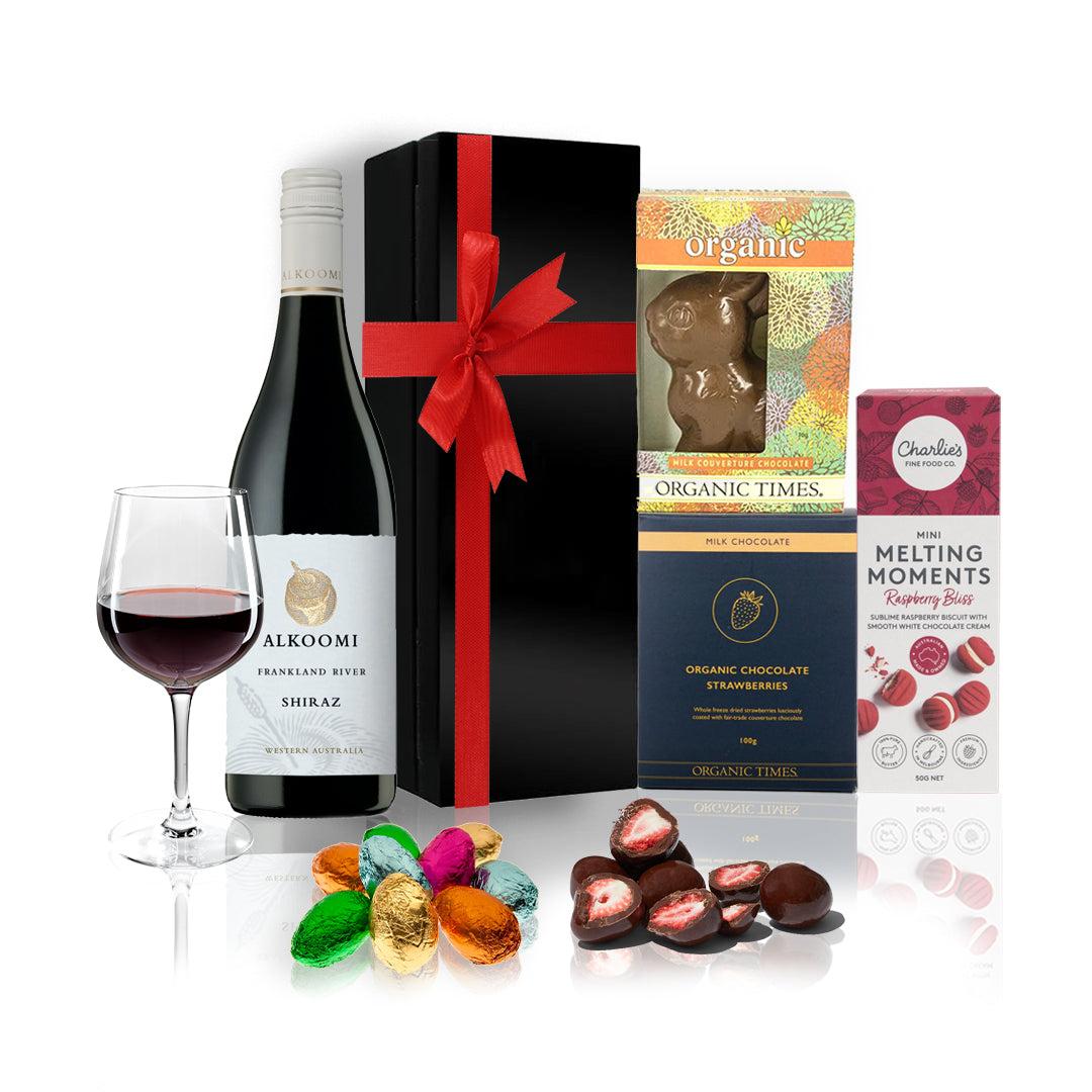 Easter With Wine Gift Hamper featuring Alkoomi Shiraz, organic chocolates, and mini Easter eggs in an elegant black box with a red bow.