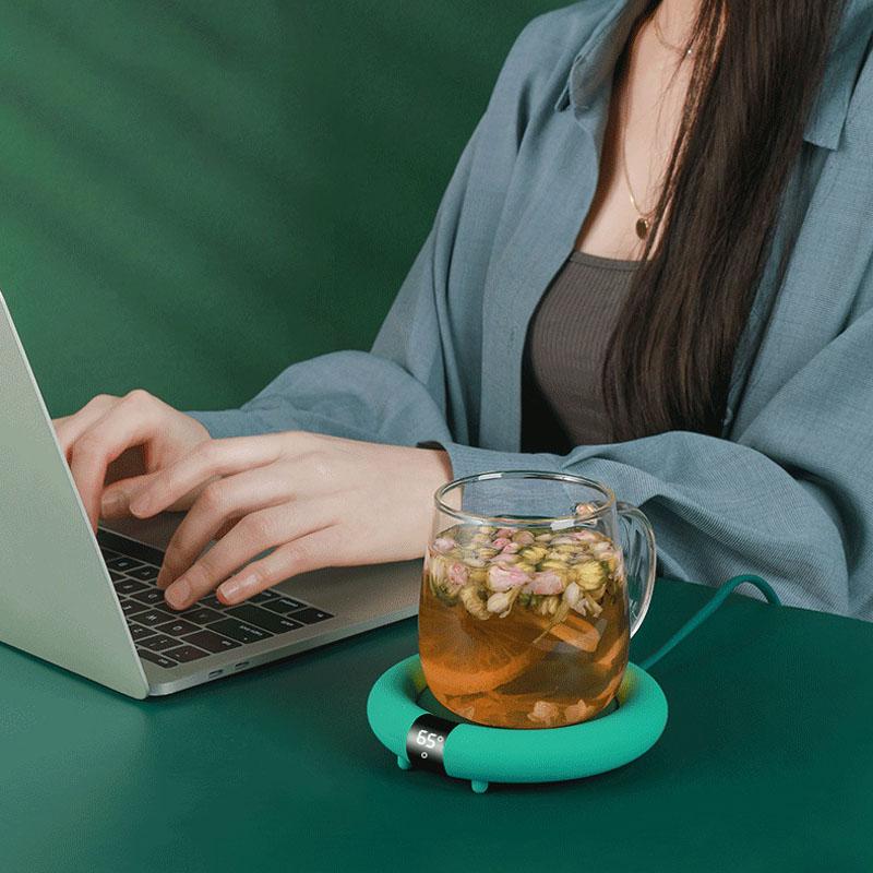 Electric Cup Warmer keeping a cup of coffee warm on a desk.