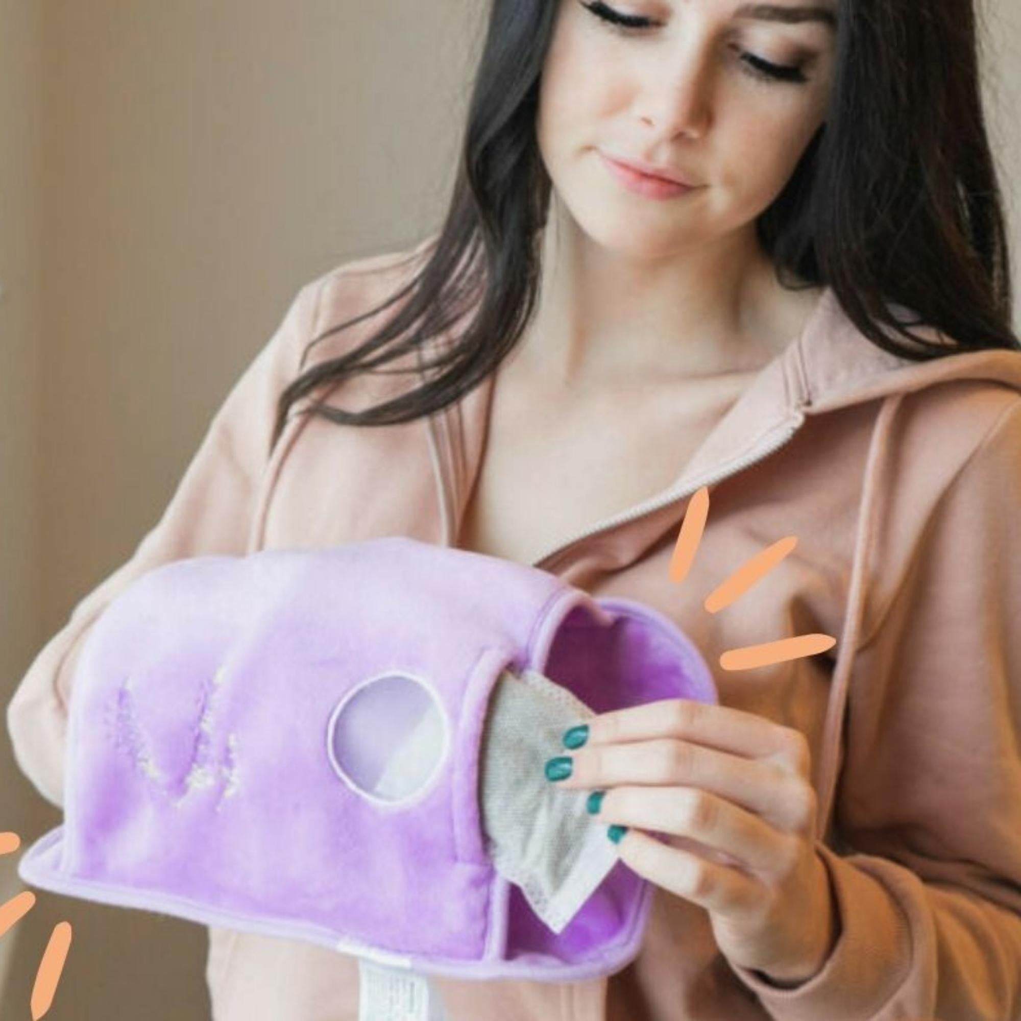 A lavender Electric Hand Warmer with a soft cover, AC adaptor, and lavender sachet, designed for soothing warmth and comfort.