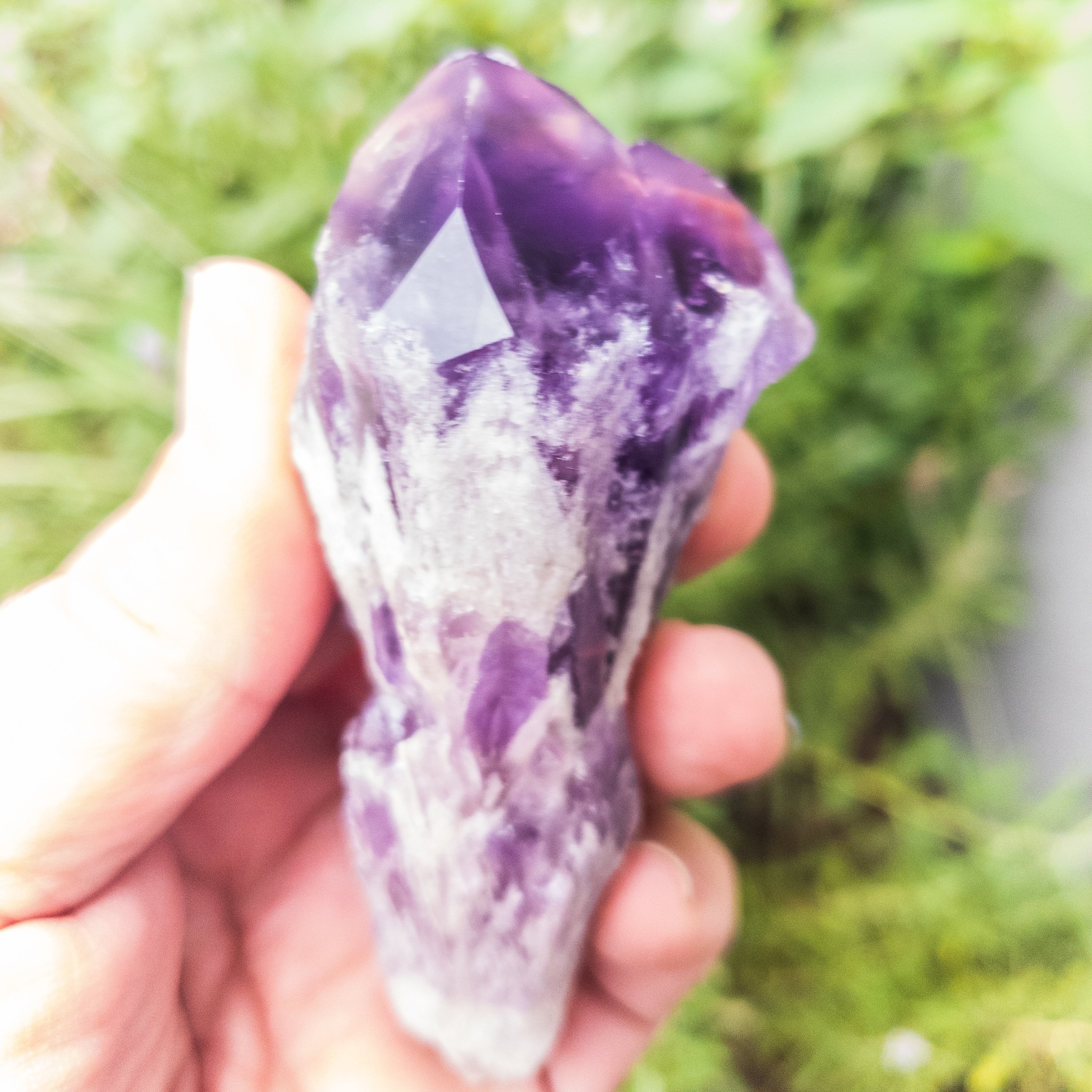 Two sizes of Elestial Amethyst Points showcasing their unique layered structure and deep purple color, perfect for meditation.