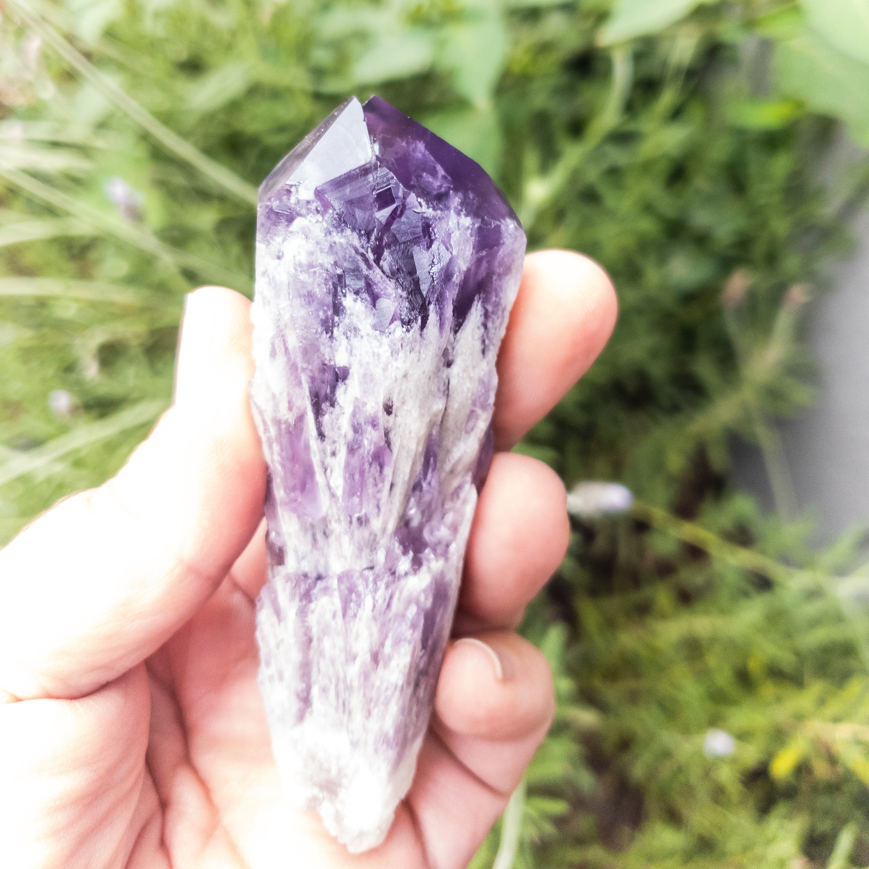 Two sizes of Elestial Amethyst Points showcasing their unique layered structure and deep purple color, perfect for meditation.