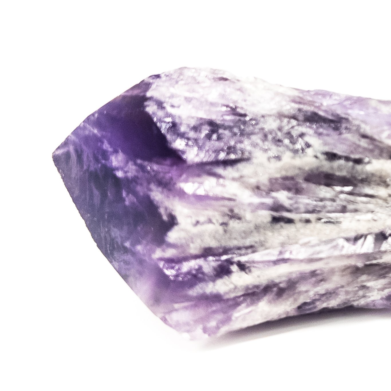 Two sizes of Elestial Amethyst Points showcasing their unique layered structure and deep purple color, perfect for meditation.