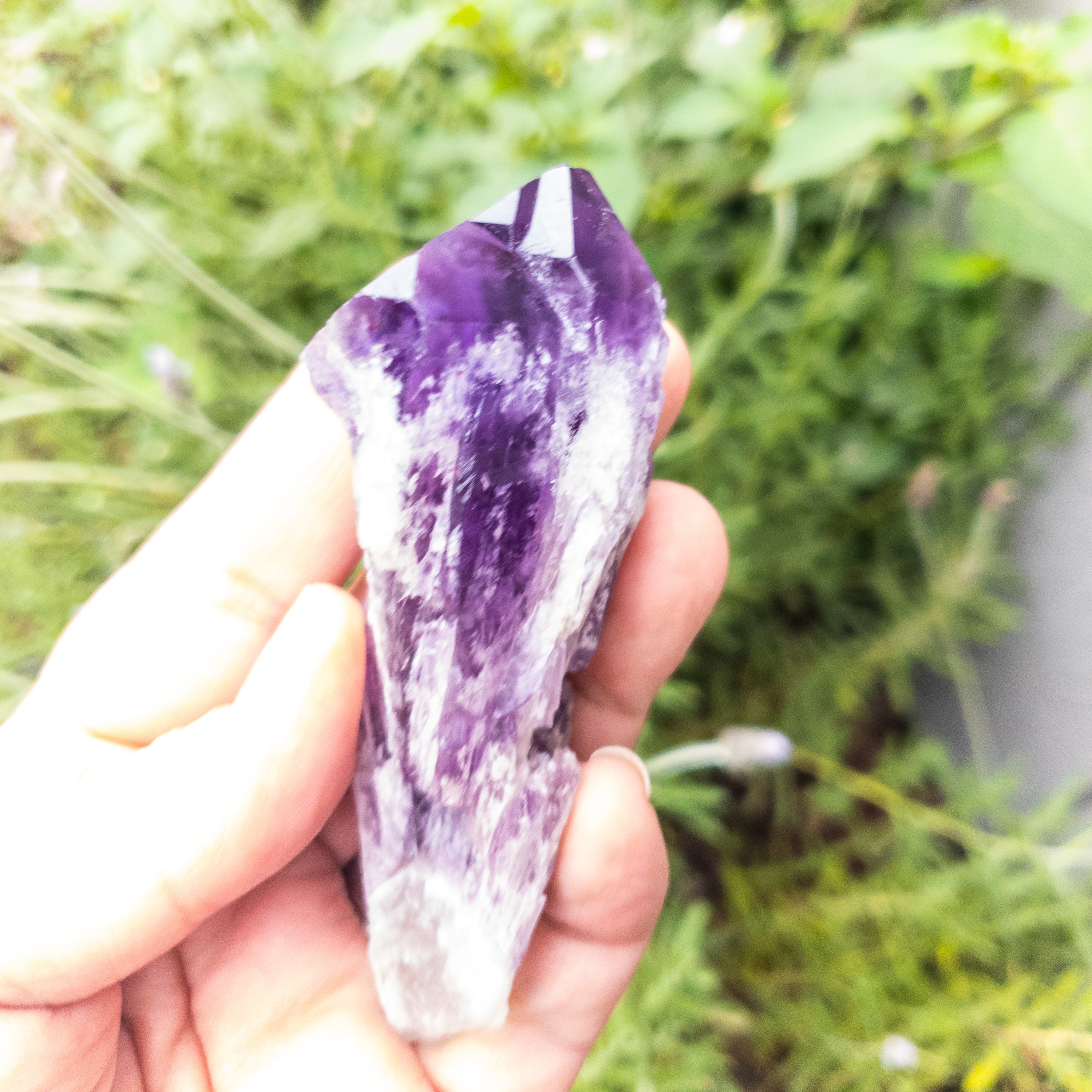 Two sizes of Elestial Amethyst Points showcasing their unique layered structure and deep purple color, perfect for meditation.