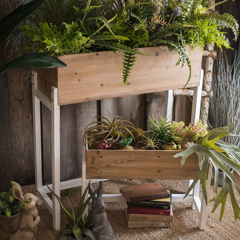 Elevated Wood Planter Box in light brown with a white stand, showcasing three sizes for versatile gardening.