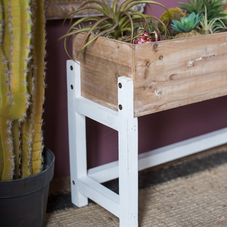 Elevated Wood Planter Box in light brown with a white stand, showcasing three sizes for versatile gardening.