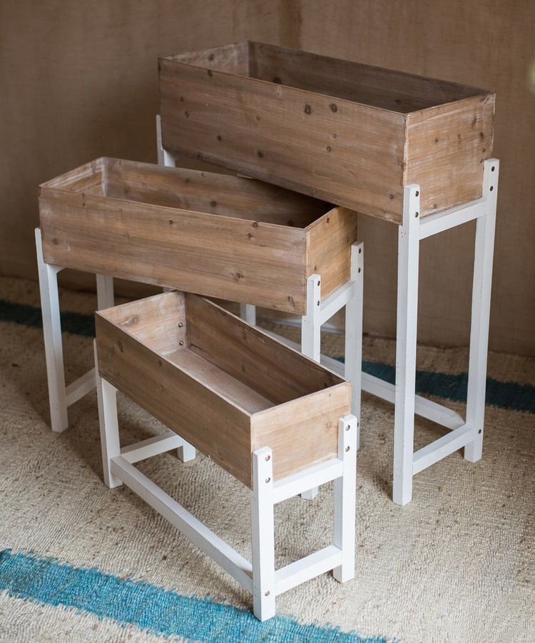 Elevated Wood Planter Box in light brown with a white stand, showcasing three sizes for versatile gardening.