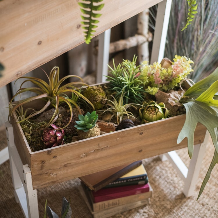 Elevated Wood Planter Box in light brown with a white stand, showcasing three sizes for versatile gardening.