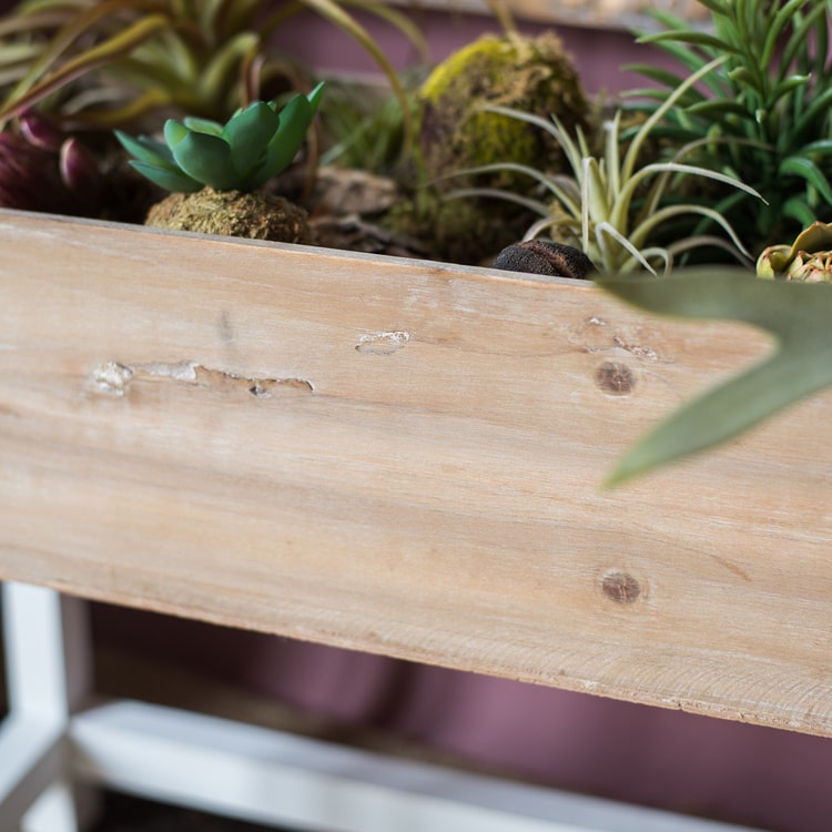 Elevated Wood Planter Box in light brown with a white stand, showcasing three sizes for versatile gardening.