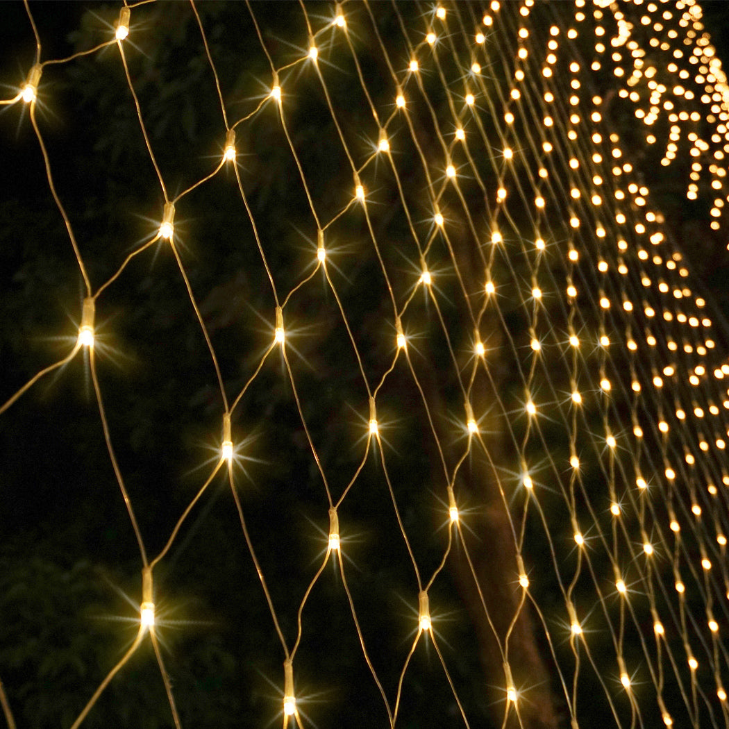 EMITTO 300LED Christmas Net Lights displayed in a festive setting, showcasing their warm white glow and mesh design.