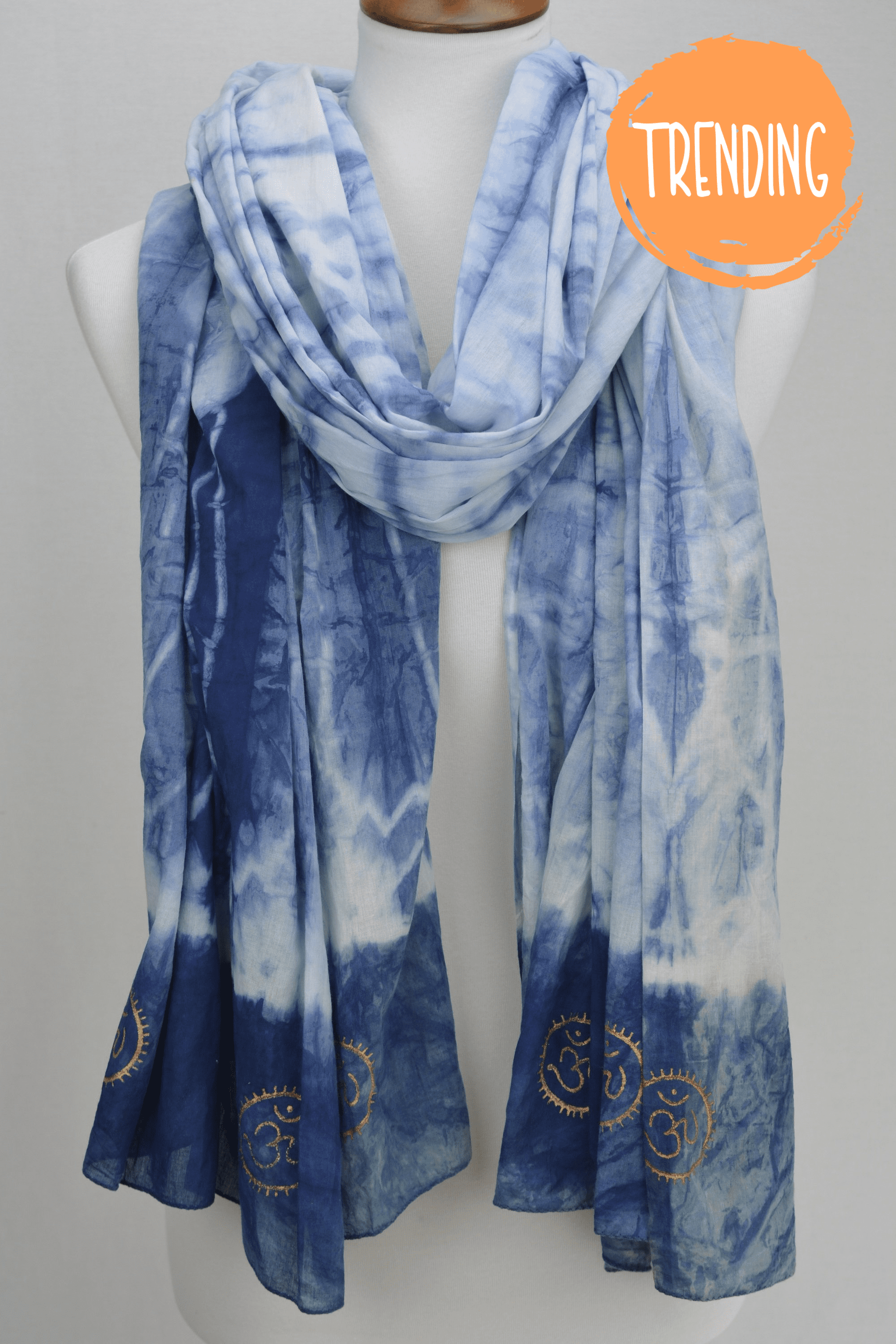 Eternity Indigo Cotton Scarf featuring hand-dyed indigo fabric and golden OM symbols at both ends.